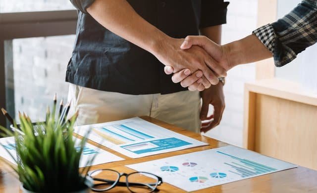 Business people handshake for teamwork of business merger and acquisition